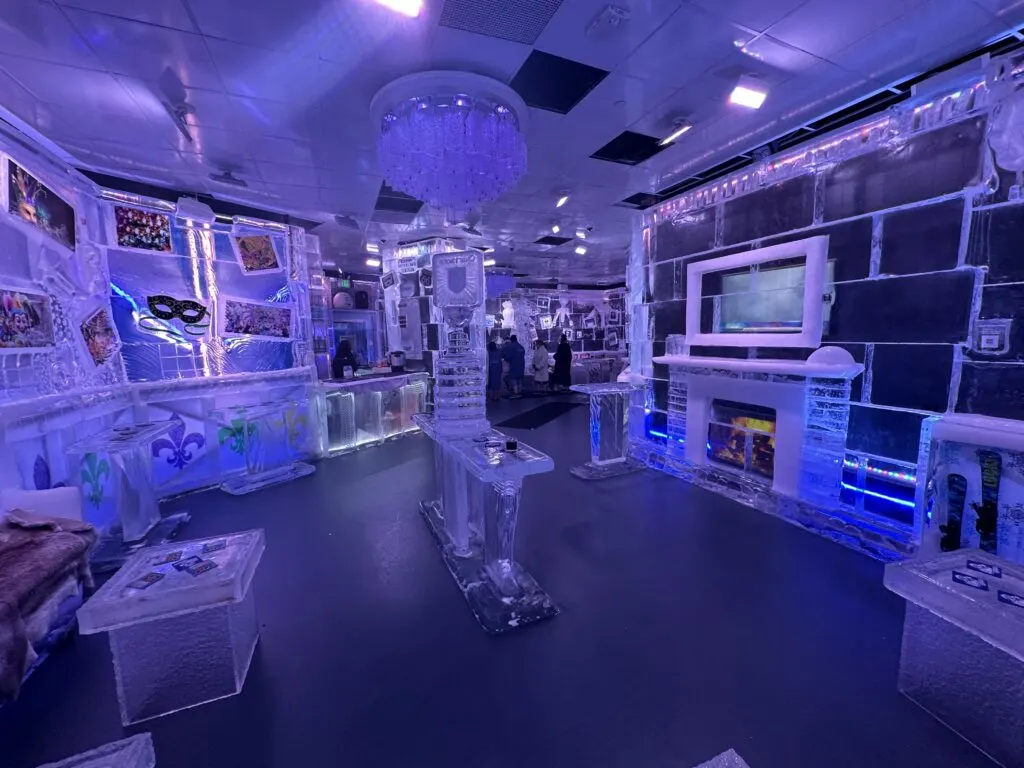 A wide angle photo of the Icebar which features a faux fireplace on the right and the bar on the left. 