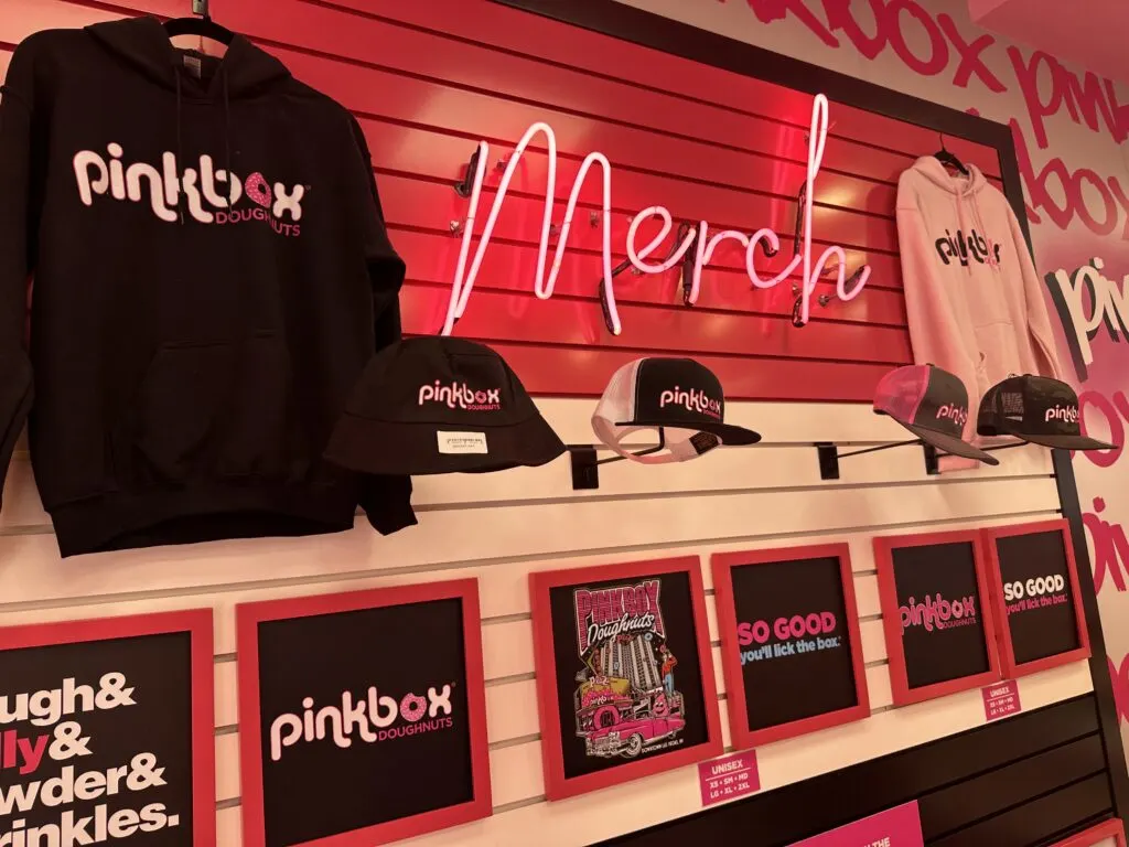 Sweatshirts, hats, and shirts with the Pinkbox logo on it.