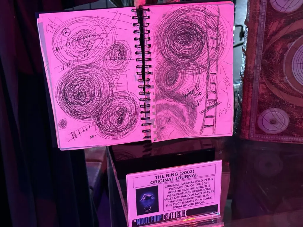 An open notebook showing circular scribbled drawings used in the movie "The Ring".
