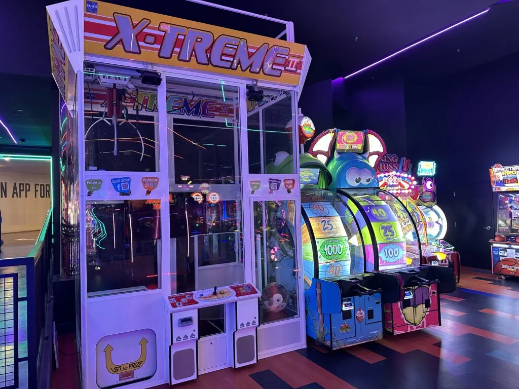 A massive Xtreme Claw Game with a few other games in the background. 
