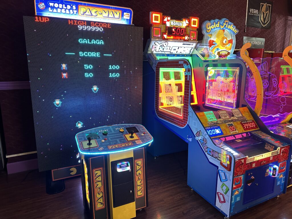 An big screen Pac Man/Galaga arcade game.