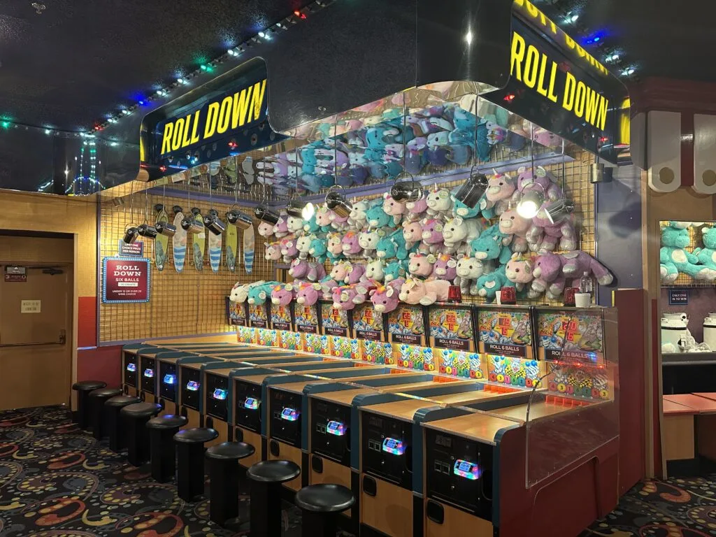 A carnival game where players earn points by rolling a ball into slots at the end of a ramp that are worth more points.