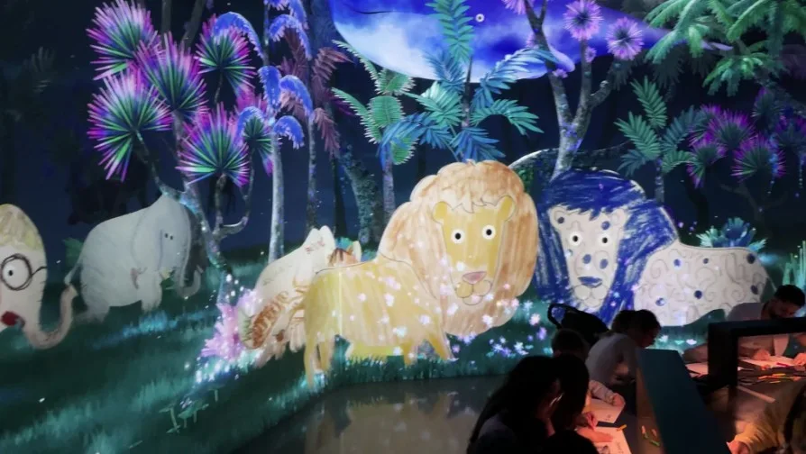 An illustrated lion, walks across the screen with other people's creations.