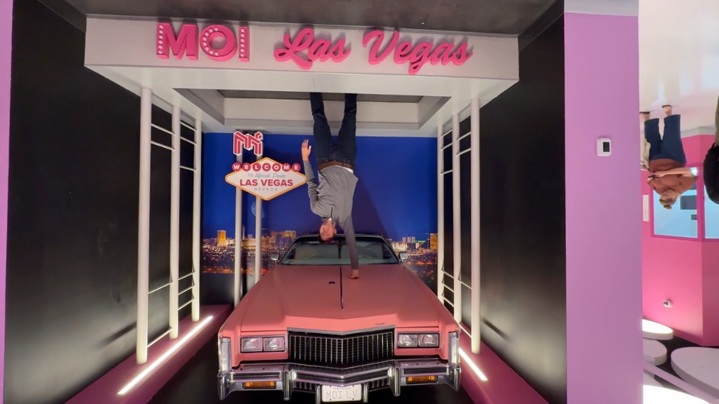 Me, in a photo op that makes it look like I am doing a one handed handstand on a car.