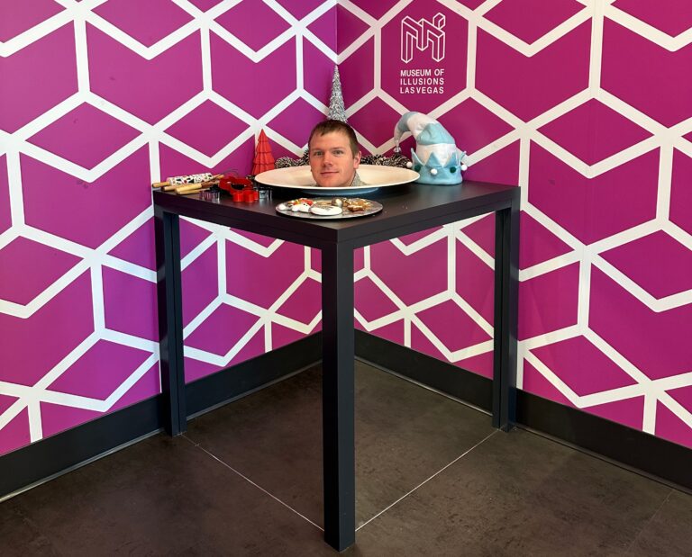 A human head appears to be served on a platter on top of a table.