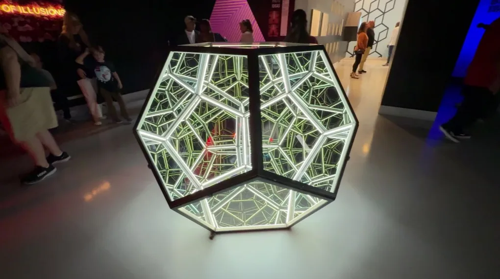 An illuminated shape of sorts in the middle of the museum.