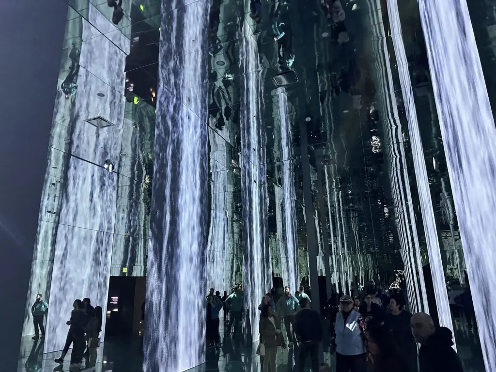 Digitally producec waterfalls extend from floor to ceiling.