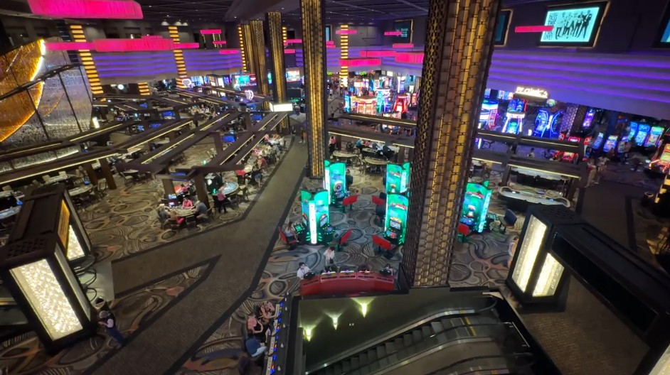 A shot of the casino floor from above, with slot machines illumnated all over the place. 