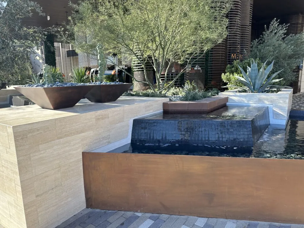 Plant life grows around a water feature at Durango near the entrance.