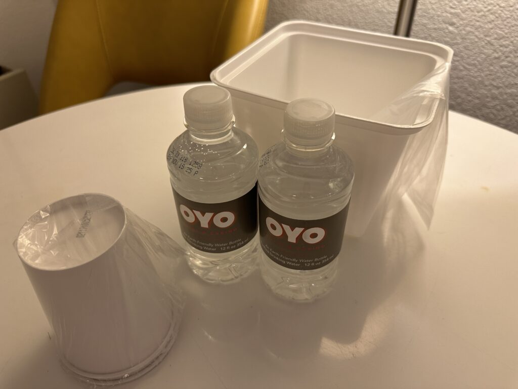 2 tiny bottles of water next to an ice bucket. 