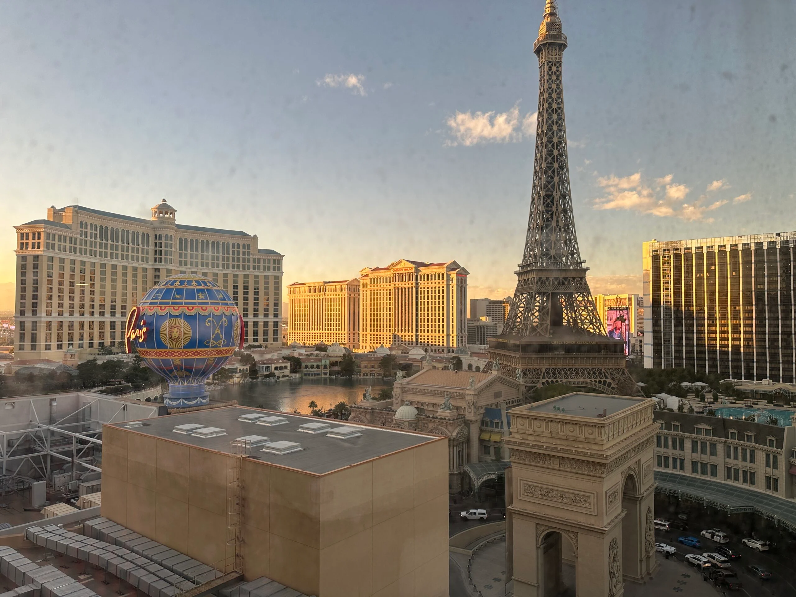 View out the window at dusk. Visible are Bellagio, Caesars Palace, and Paris' Eiffel Tower.