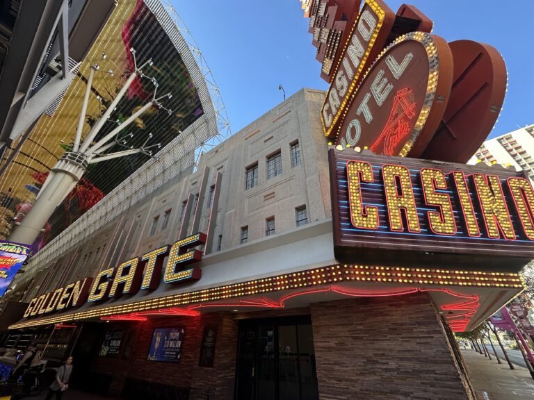 A close shot of Golden Gate's exterior signage, which is still illuminated in the morning.