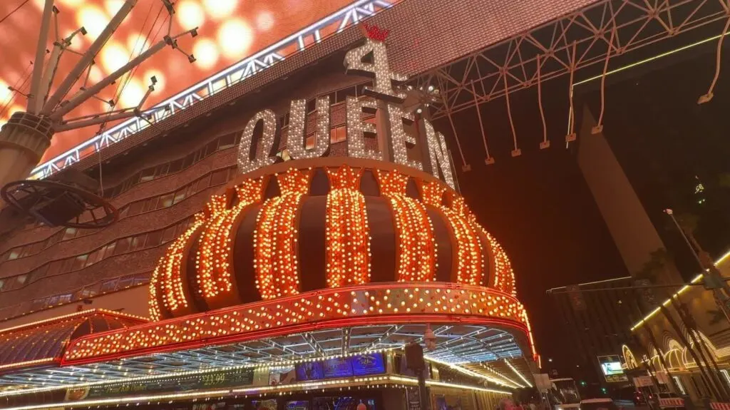 Exterior facade of 4 Queens at night.