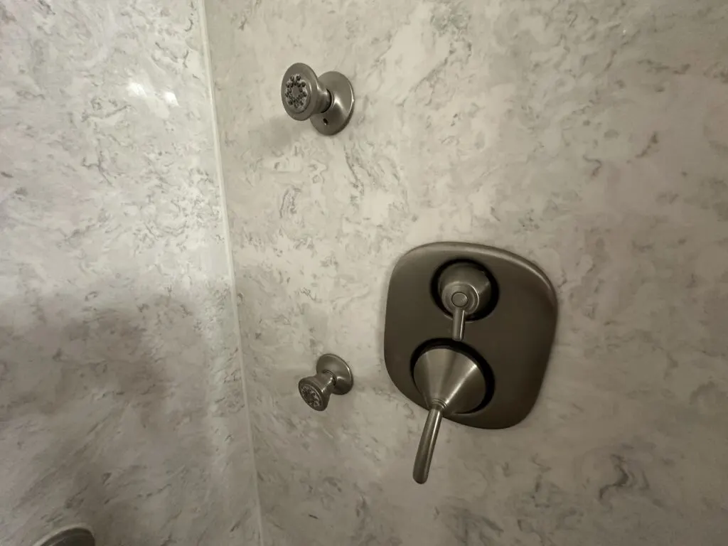 Body jets spraying on the back wall of the shower.