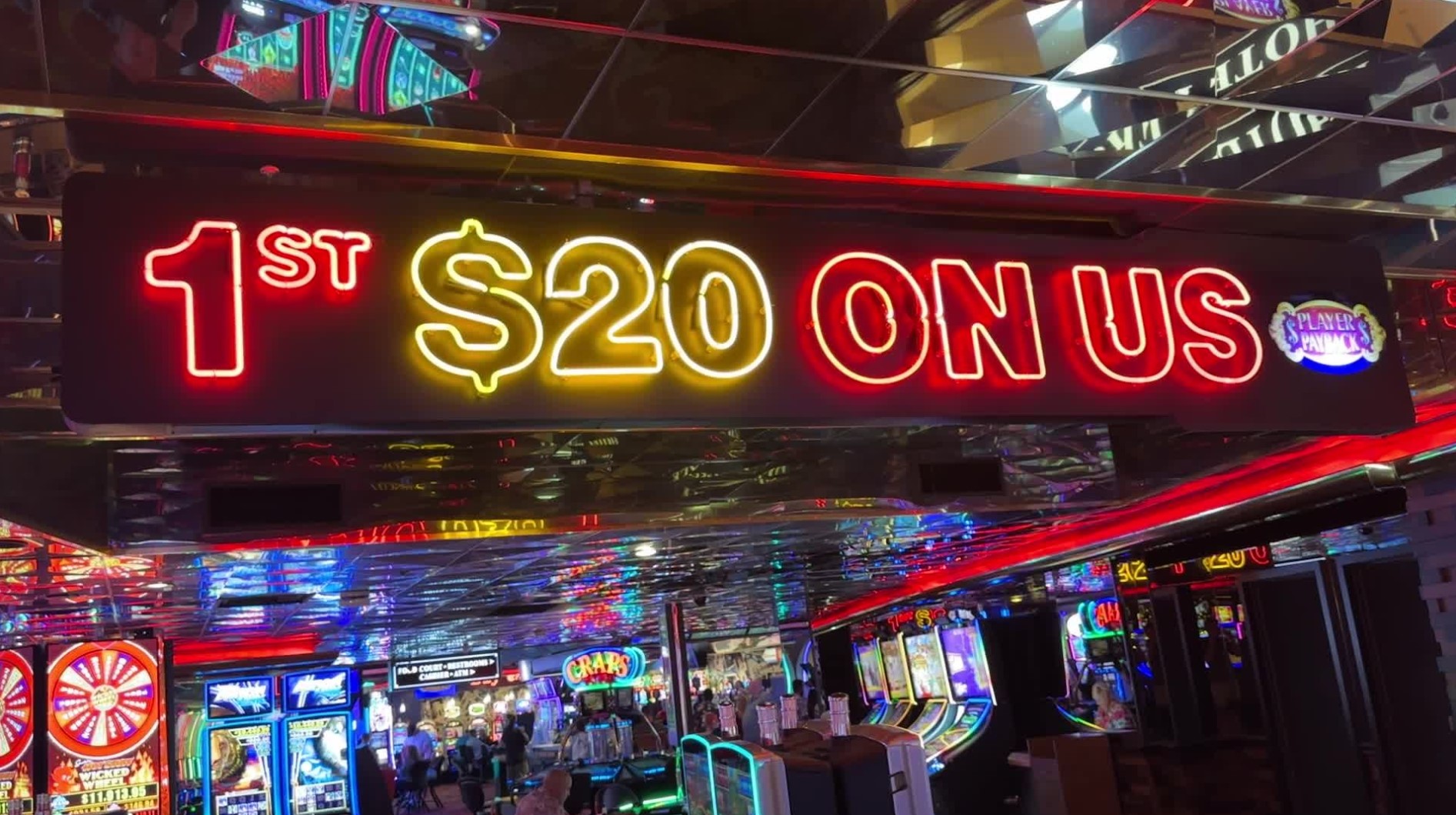 A neon sign that says "1st $20 on us".
