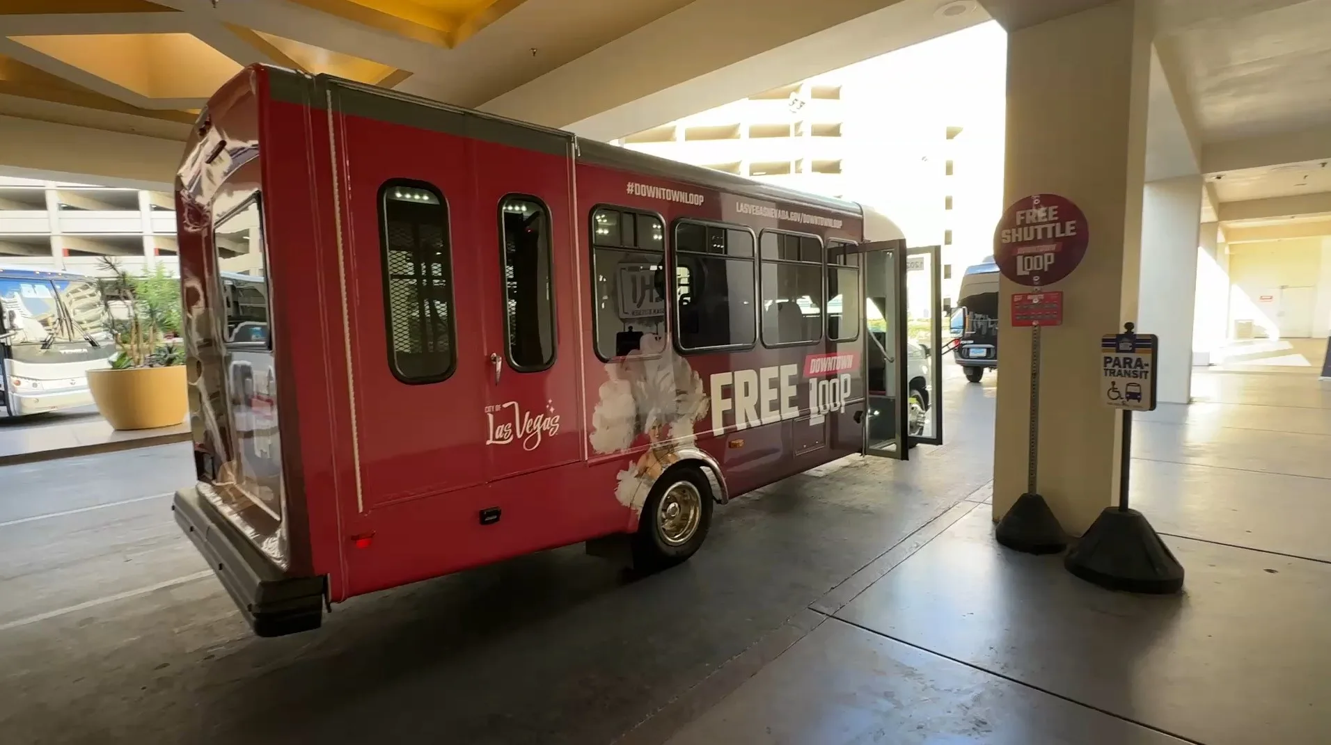 A small red bus parked at STRAT.