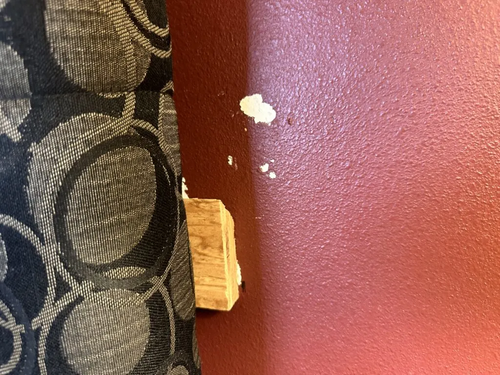 A white gouge in a red wall.