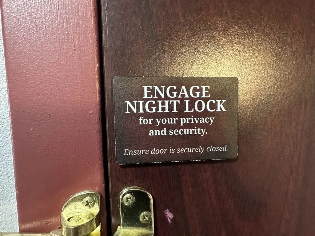 Warning on the door that says "Engage the Night Lock"