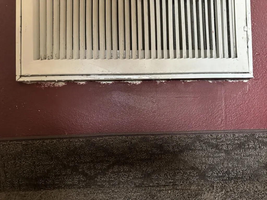 Sloppy detail paintwork underneath the HVAC vent.