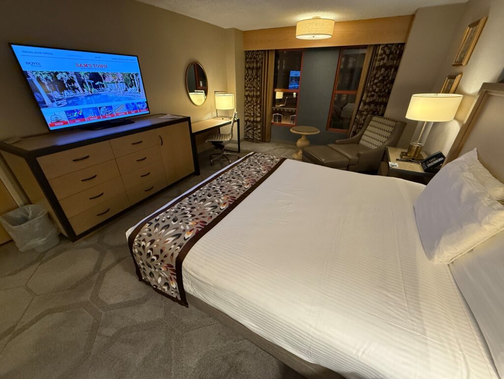 A view of the TV Stand from the corner of the room with the king bed in the foreground. 