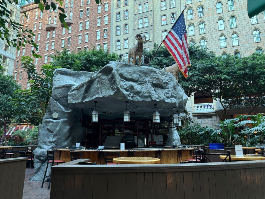 A bar that appears to be carved out of a rock formation overlooking Mystic Falls Park. 