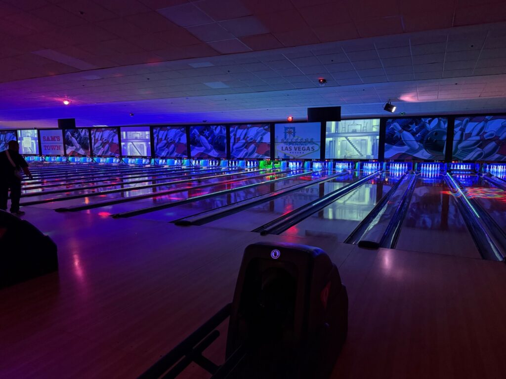 A dimly lit bowling alley. 