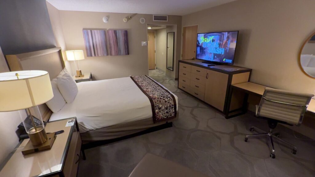 A reviews view of the room with the king bed on the left and the TV stand in the background on the Right. 