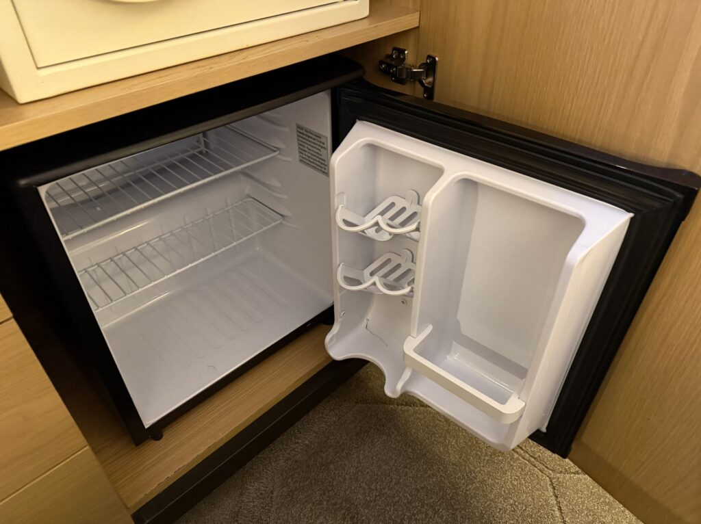 An empty and open mini-fridge. 
