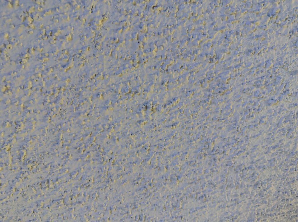 A closeup of the popcorn ceiling. 