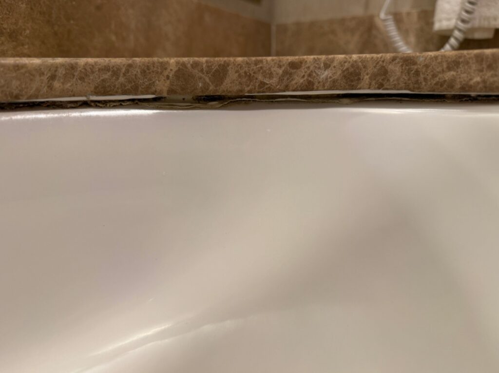A deteriorating caulk line between the sink and countertop. 