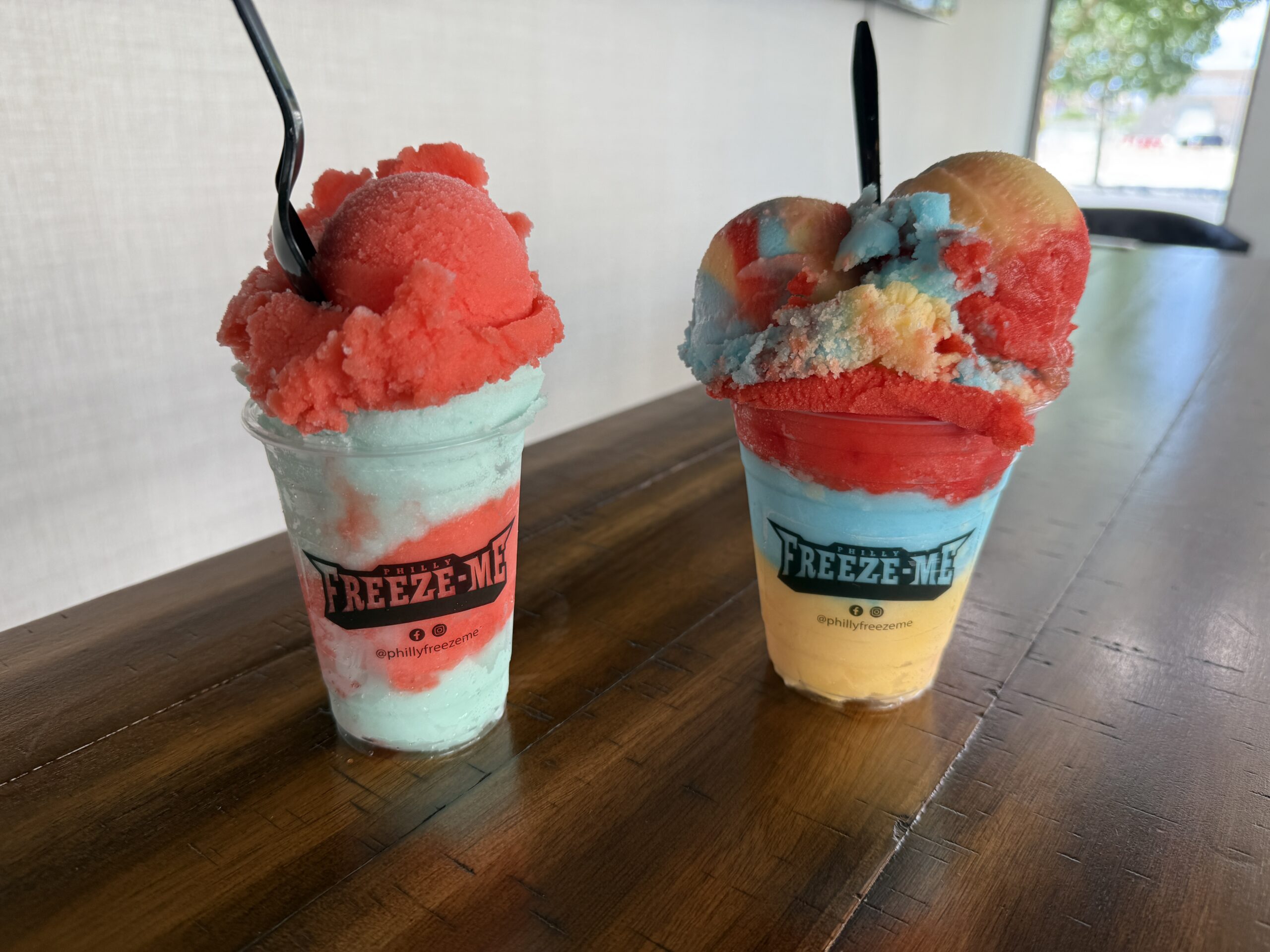 2 Colorful Freeze-Me's at Philly Freeze on a table.