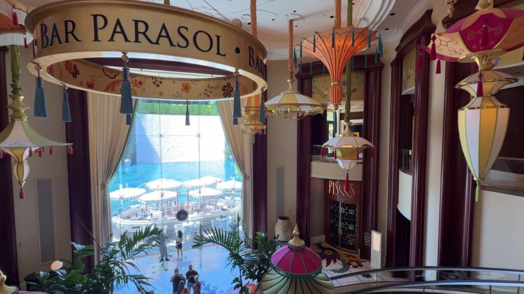 Bar Parasol Entrance with Lake Of Dreams Theater waterfall in the background. 