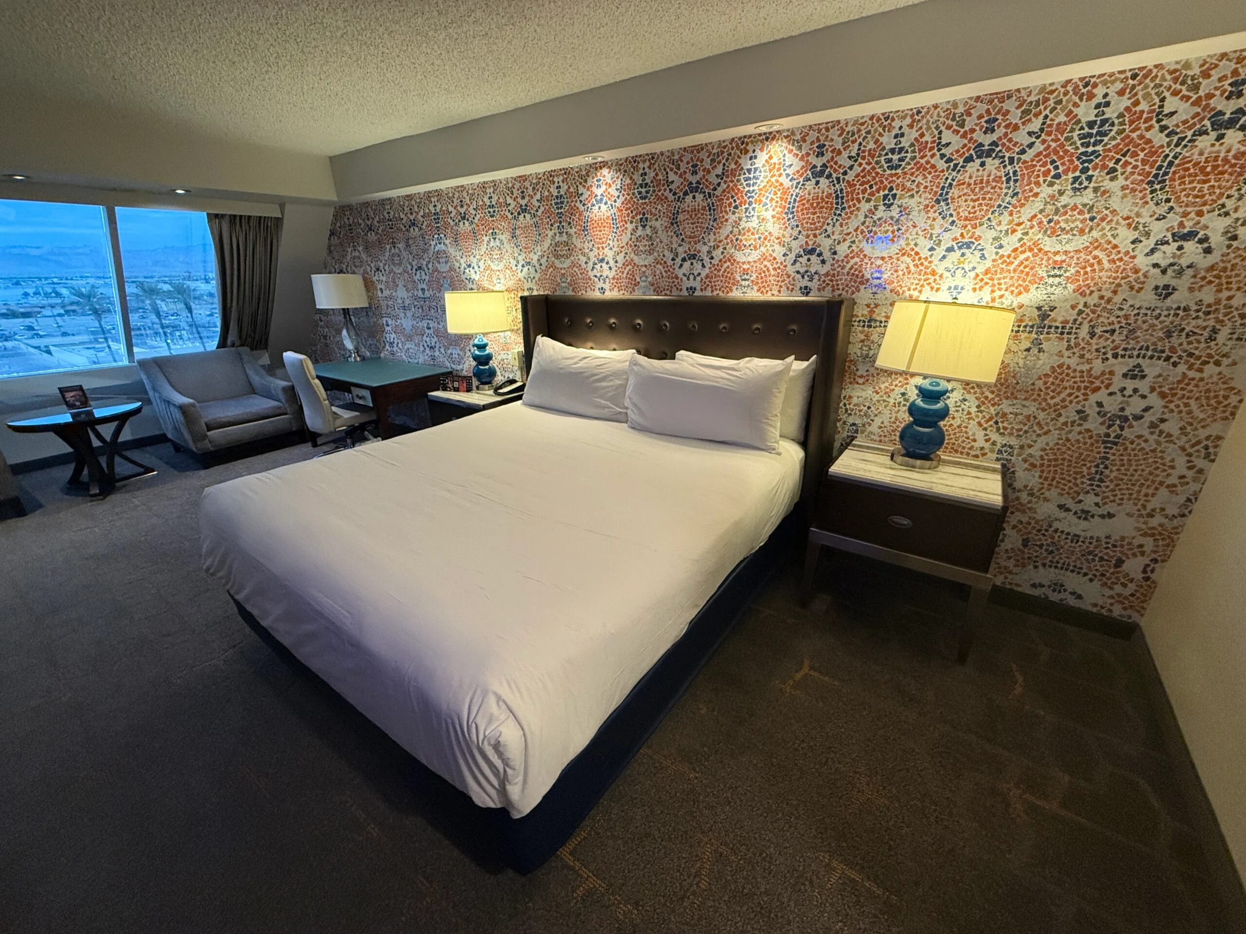 Luxor's Pyramid Premier room, with a king bed in front of a colorful accent wall.