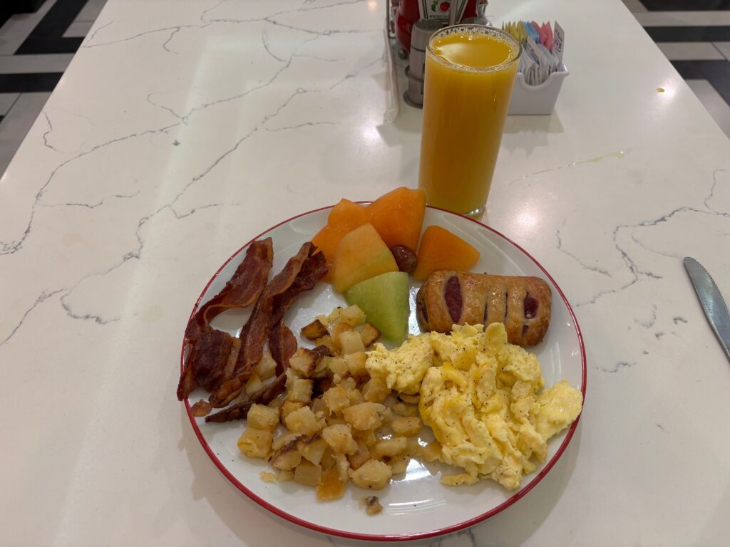 A plate wtih an assortment of food on it from STRAT Cafe's breakfsast Buffet. 