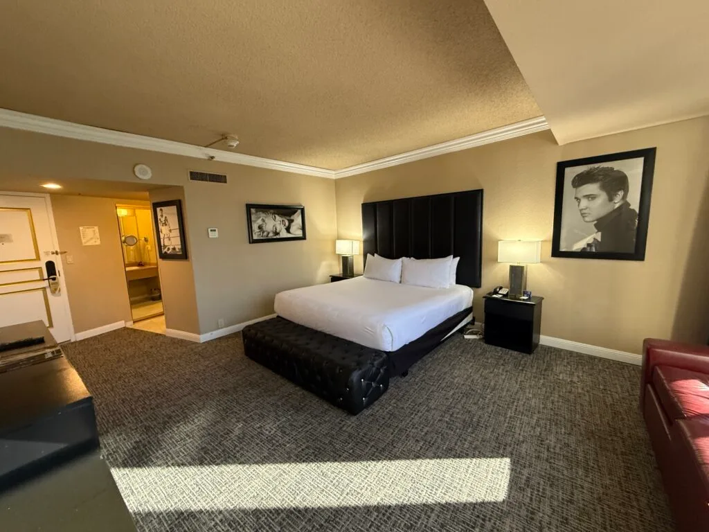 Wide angle of the room with a king bed, flanked by pictures of Elvis and Maralyn Monroe.