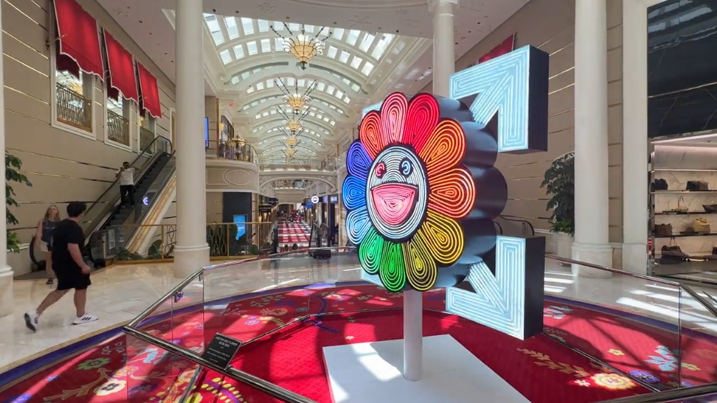 A piece of art depicting an illuminated flower in Wynn's Plaza Shops. 