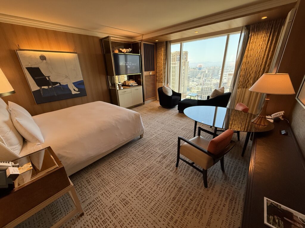 Angle of the room that shows the king bed pointed at the open window. 