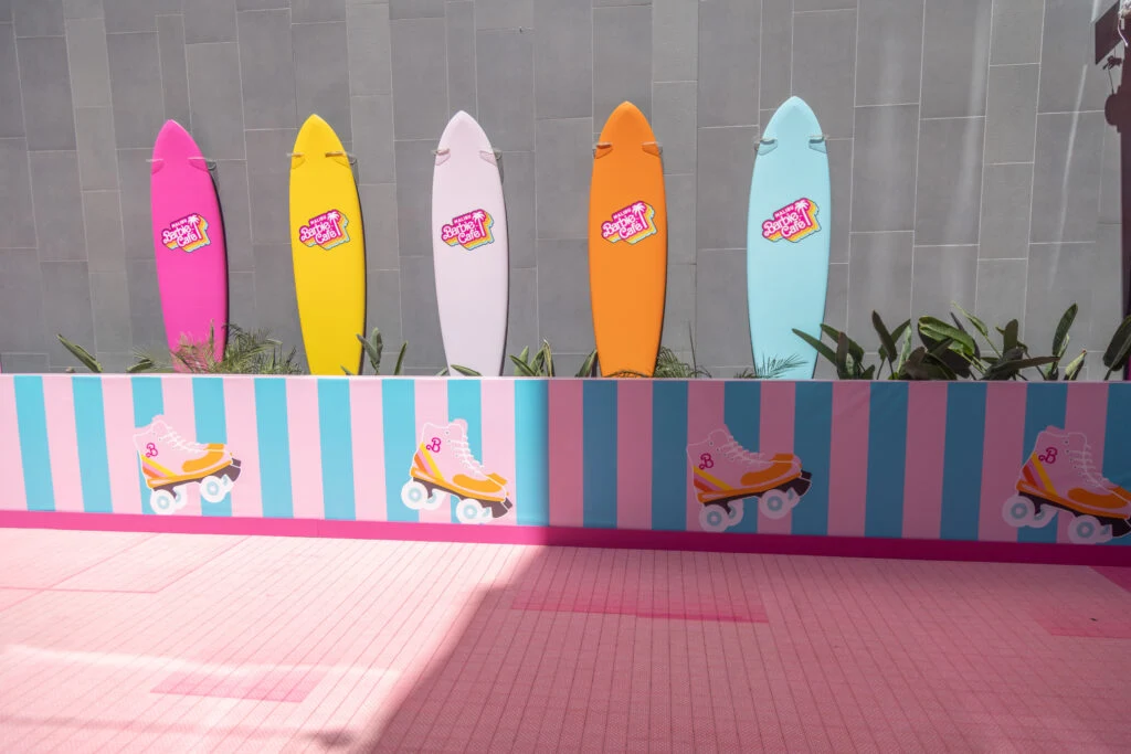 Surfboards on a wall along the roller rink. 