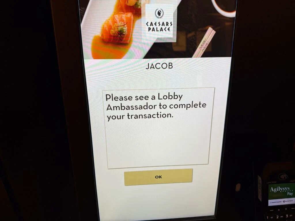 A self check in screen that says "Please see an ambassador".