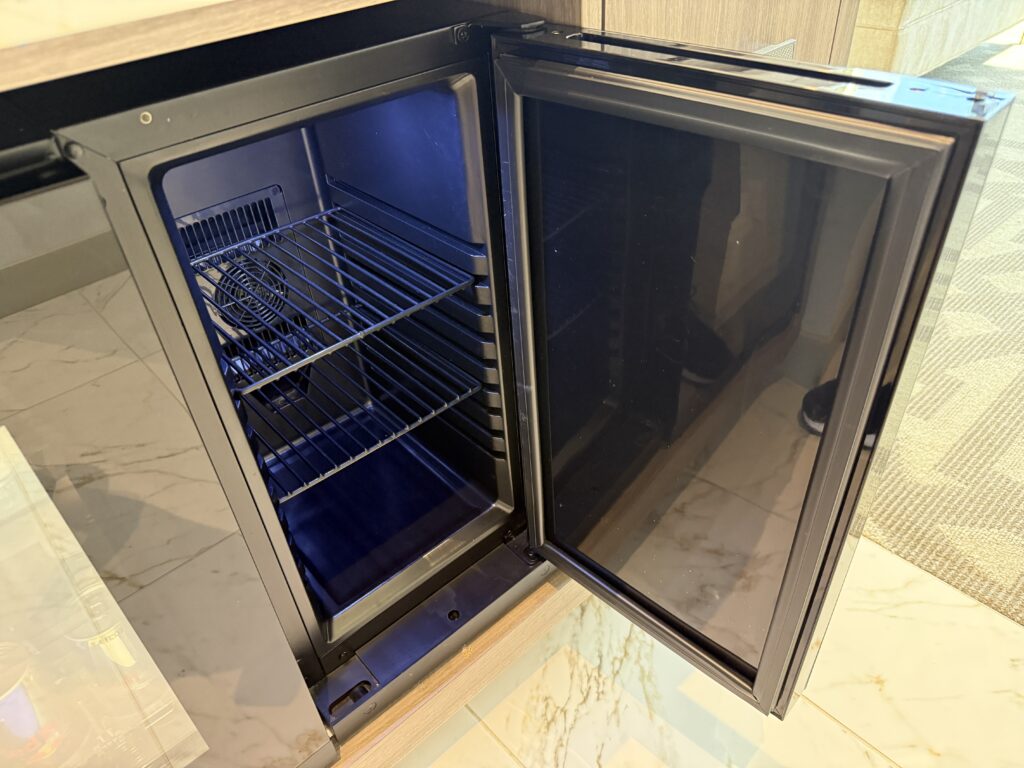 An empty mini fridge, opened.