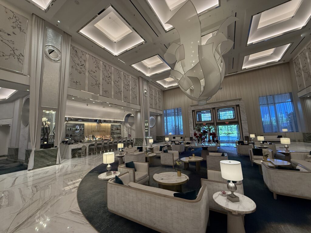 The hotel lobby, which has high ceilings, decorative lighting, and a gorgeous aesthetic.