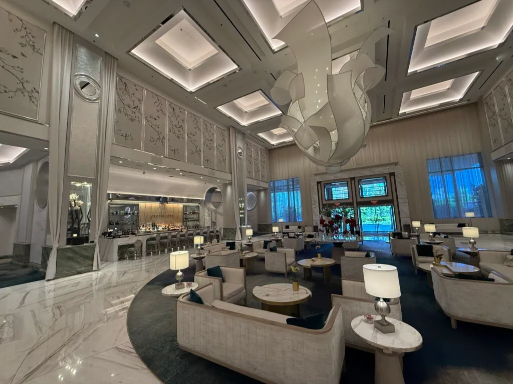 The hotel lobby, which has high ceilings, decorative lighting, and a gorgeous aesthetic. 