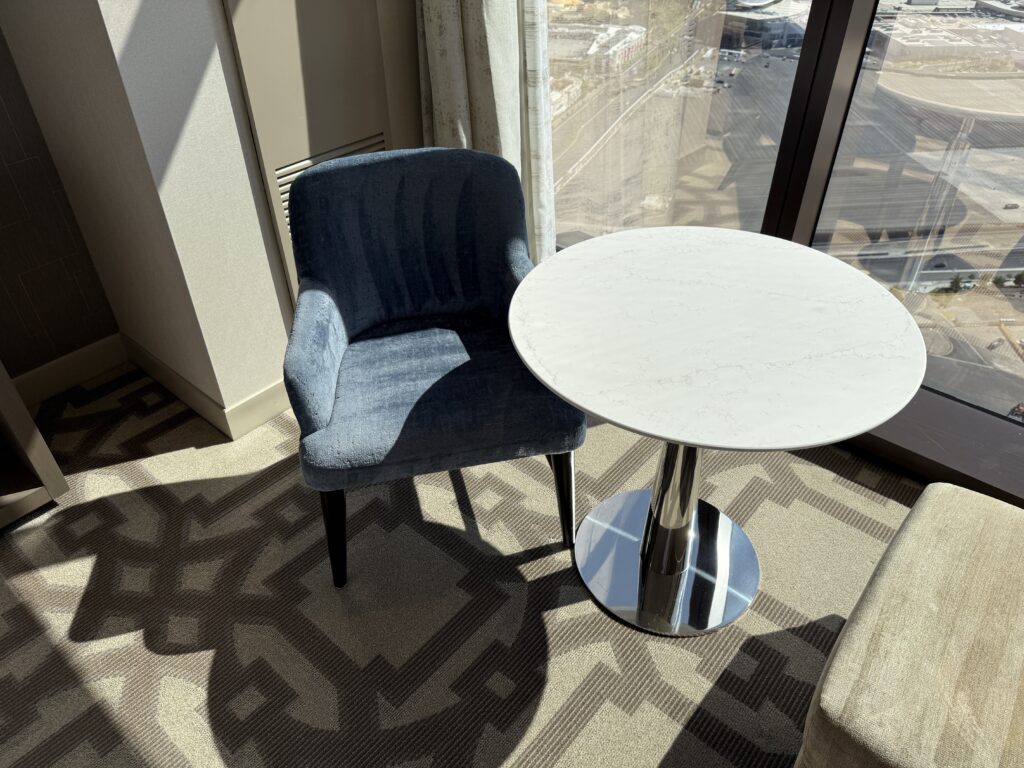 A blue chair next to a small table with visible vaccuum lines.
