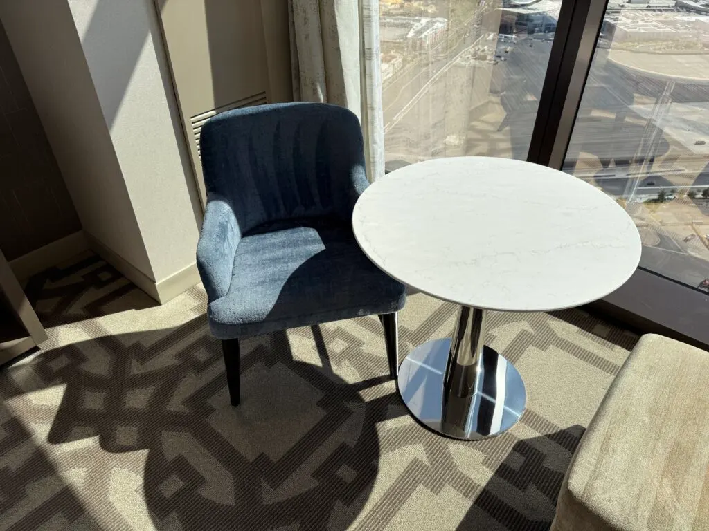 A blue chair next to a small table with visible vaccuum lines. 