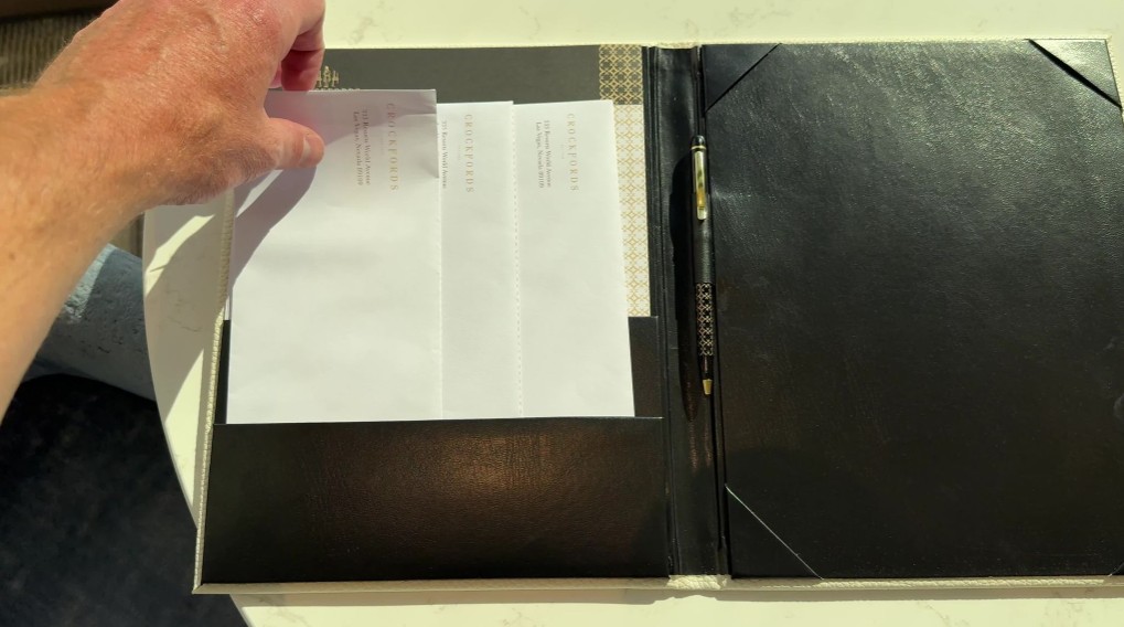 A black folio opened to show envelopes and stationary.