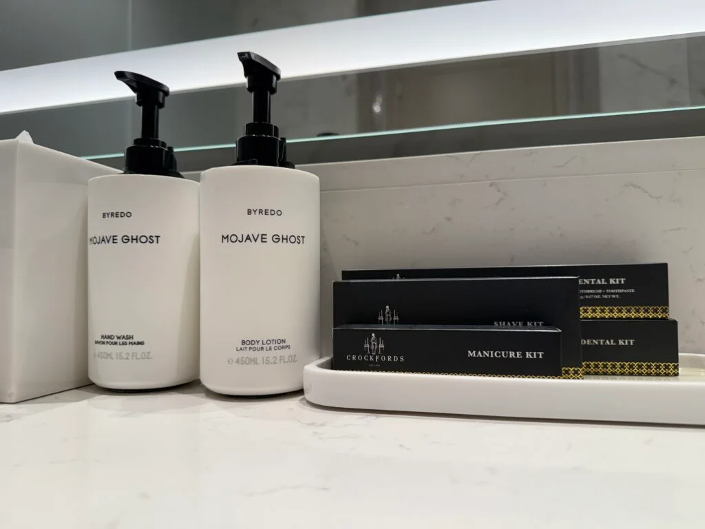 A tray of toiletries next to pump soaps. 