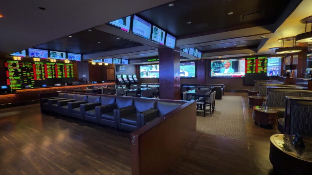 A small room with seating, surrounded by TVs.