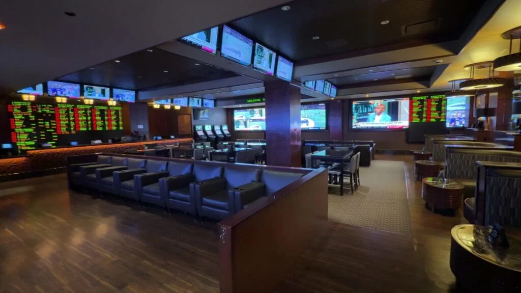 A small room with seating, surrounded by TVs. 