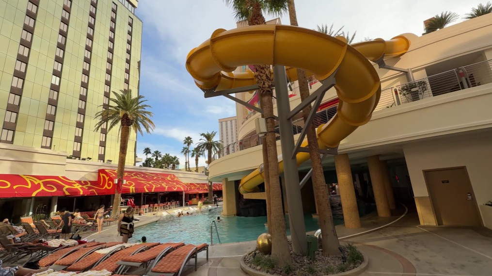A yellow waterslide winds above the pool scene.