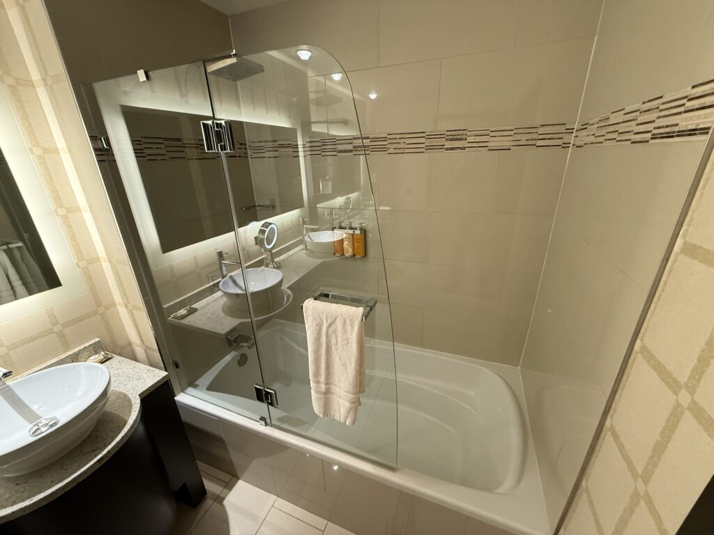 Tub/shower combo with a glass wall to keep water in.